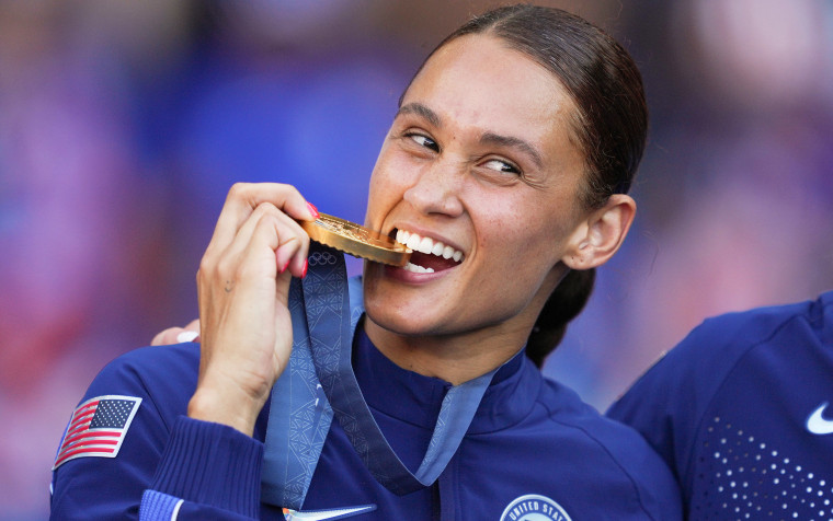 Lynn Williams from the United States bites into her gold medal.