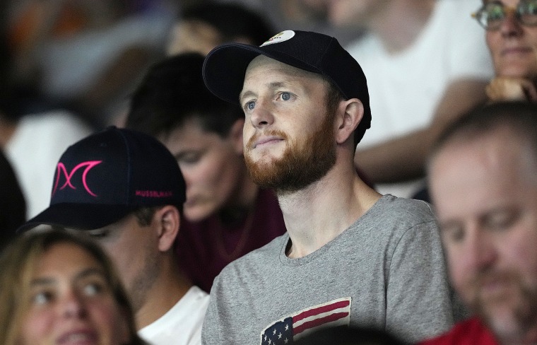 Pat Woepse, center, husband of the U.S. player Maddie Musselman, watches a match during a women's Water Polo.