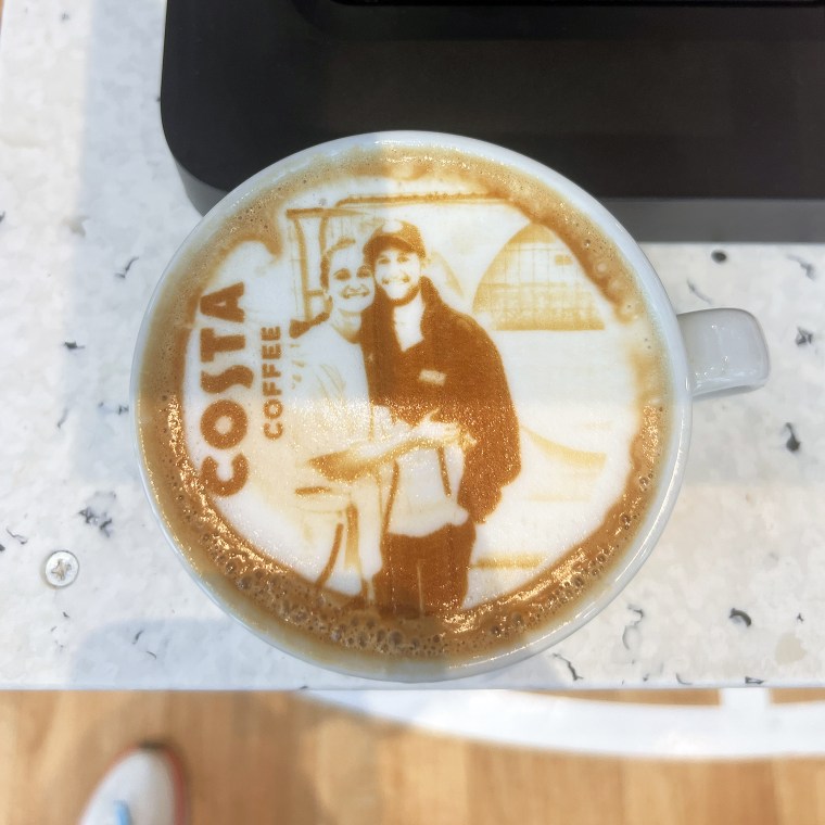 A coffee with the couple's face printed in foam at an Olympic Village coffee shop.