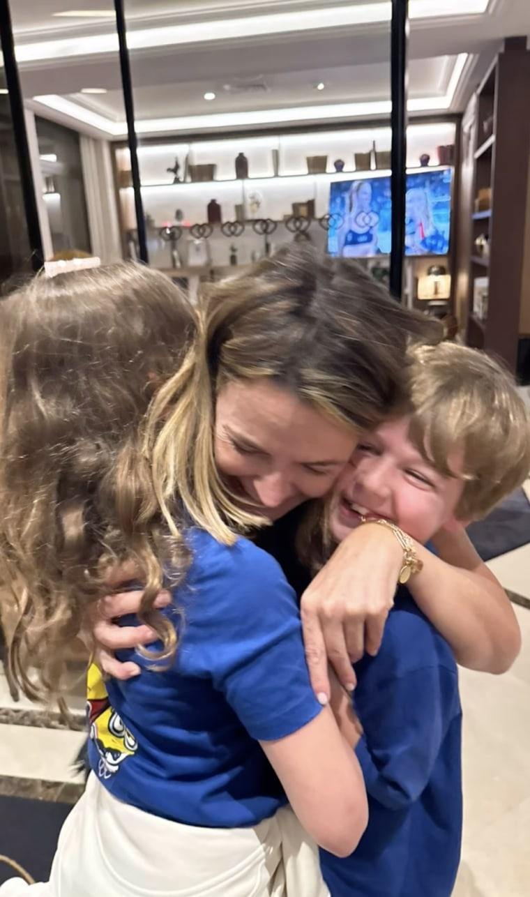Savannah hugging her kids.