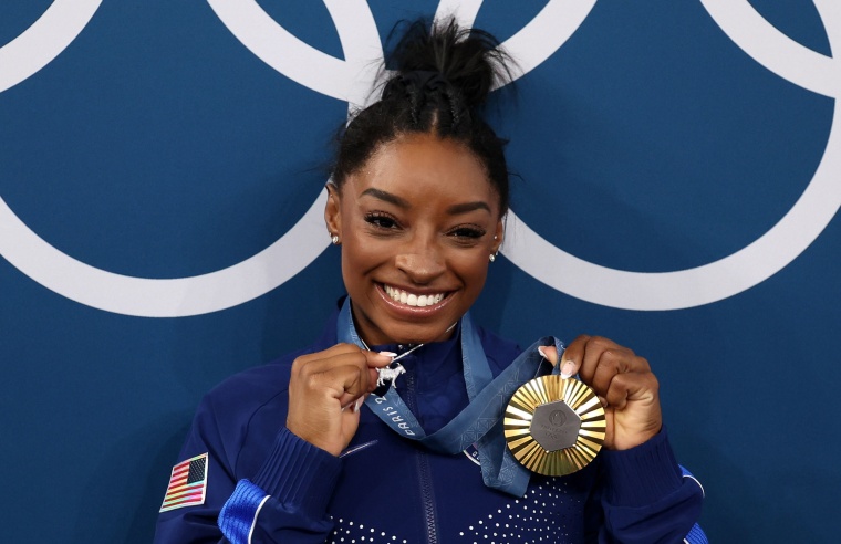 US' Simone Biles poses her goat necklace after the artistic gymnastics women's all around final of the Paris 2024 Olympic Games at the Bercy Arena in Paris, on August 1, 2024. 