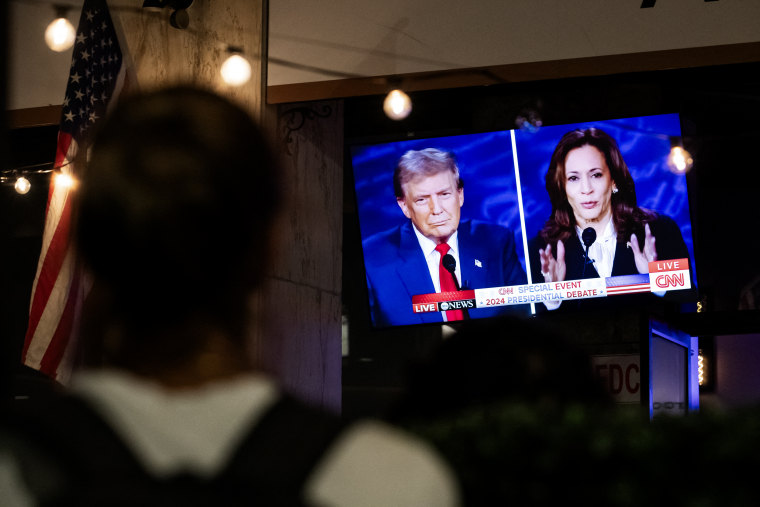 People watch the US Presidential debate between Vice President and Democratic presidential candidate Kamala Harris and former President candidate Donald Trump