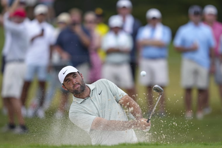 Scottie Scheffler hits the ball from a bunker on the sixth hole during the final round of the Tour Championship.