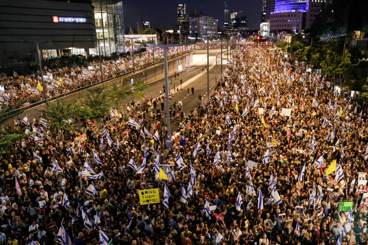 A large group of protestors gather outside on the streets