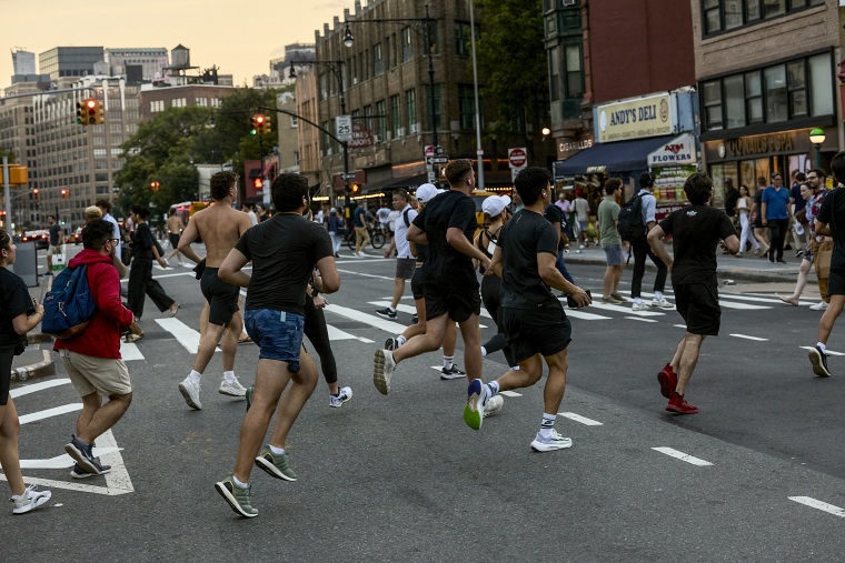 Runners cross an intersection part of the Lunge Run Club on Aug. 28, 2024.