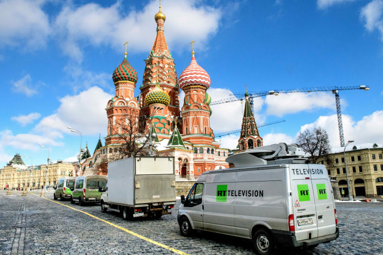 RT vans park in front of St. Basil's Cathedral and the Kremlin next to Red Square