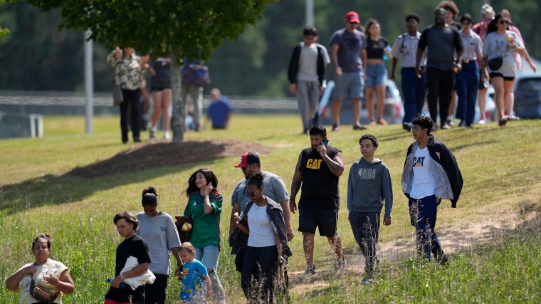 Students and parents leave the campus of Apalachee High School in Winder, Georgia on Wednesday. 