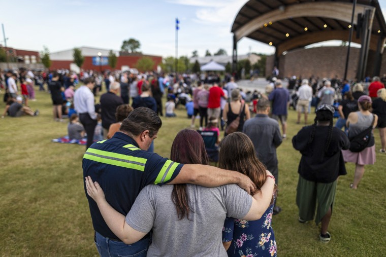 A family embraces during a vigil.