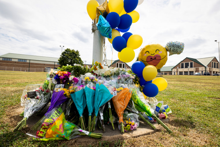 A memorial of flowers and balloons.