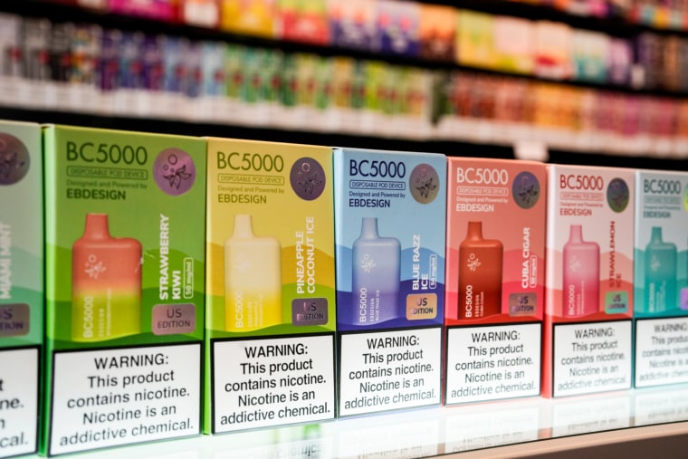 Varieties of disposable flavored electronic cigarette devices on a store shelf