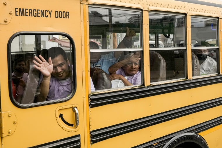 Nicaraguan citizens wave from a bus.