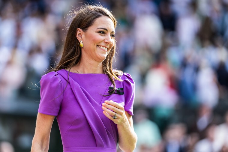 Kate Middleton smiles outside in a purple dress