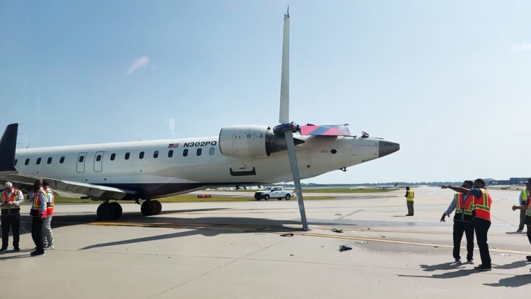 A damaged Endeavor Air plane on the tarmac at Hartsfield-Jackson Atlanta International Airport.