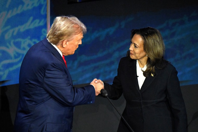 US Vice President and Democratic presidential candidate Kamala Harris (R) shakes hands with former US President and Republican presidential candidate Donald Trump during a presidential debate at the National Constitution Center in Philadelphia, Pennsylvania