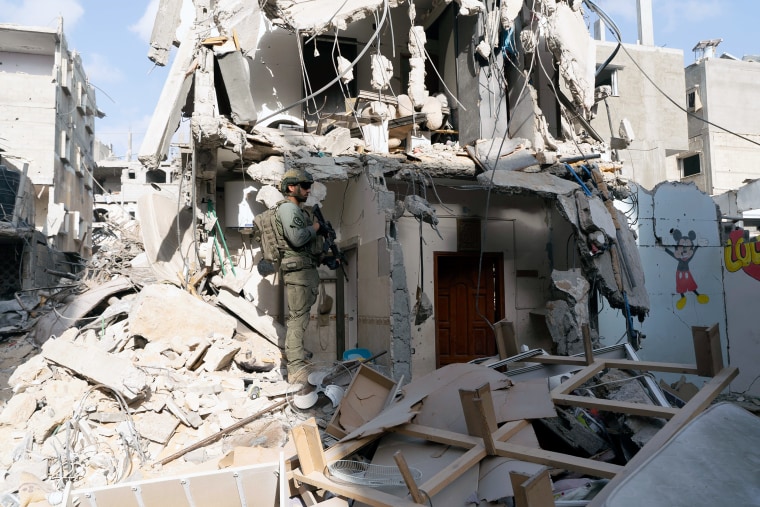 An Israeli soldier stands near the entrance to a tunnel in Rafah.