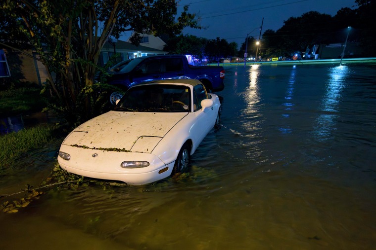 A car is submerged up to the wheel arch