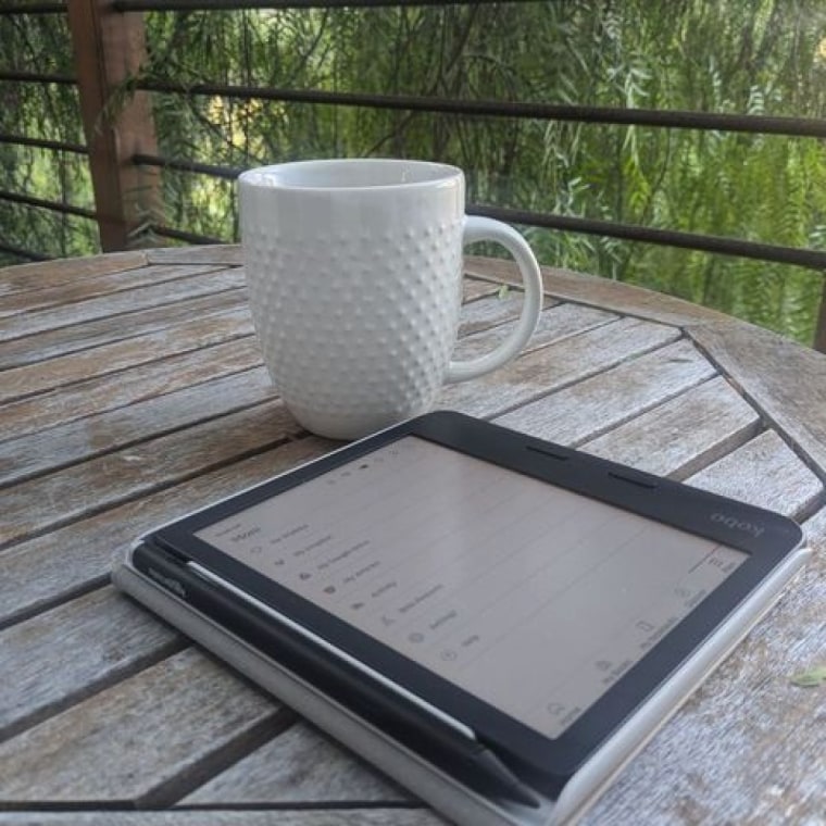 Kobo Libra Colour on a table beside a cup of coffee