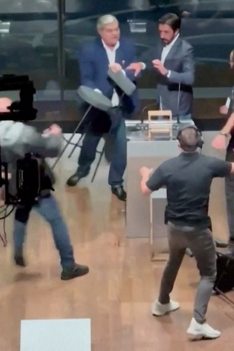 Brazilian mayoral candidate hits opponent with a chair right through are living debate