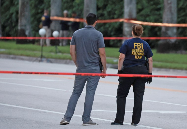 Police personnel investigate the area around Trump International Golf Club