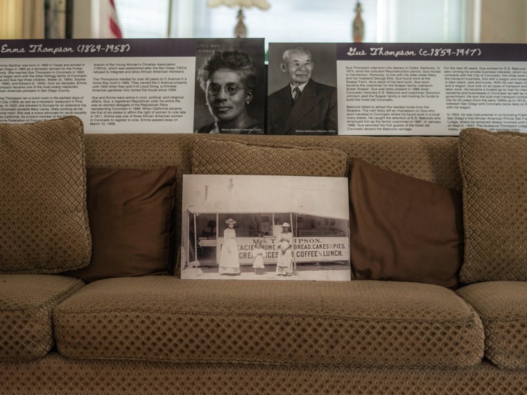 Portraits of Emma and Gus Thompson on display on a living room couch