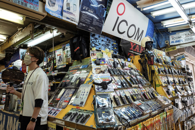 A sign with the logo of Japanese walkie-talkie maker Icom (C, top) is displayed at a shop that specialises in wireless devices in Tokyo's Akihabara electric district on September 19, 2024.