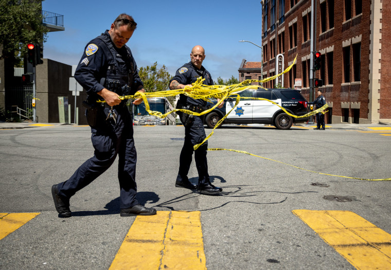 San Francisco Police Department officers remove tape at the scene of a shooting that left one high school student injured on Aug. 21, 2024.