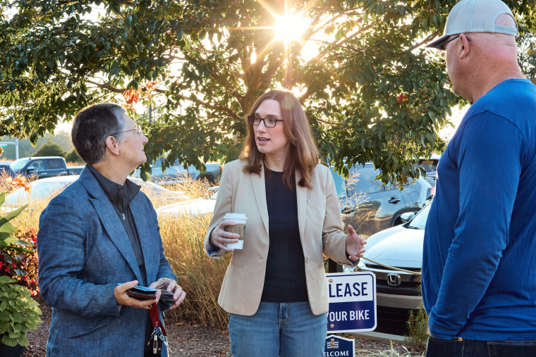 Sarah McBride, center, talks to Lisa Goodman, left, and Delaware state Sen. Russ Huxtable