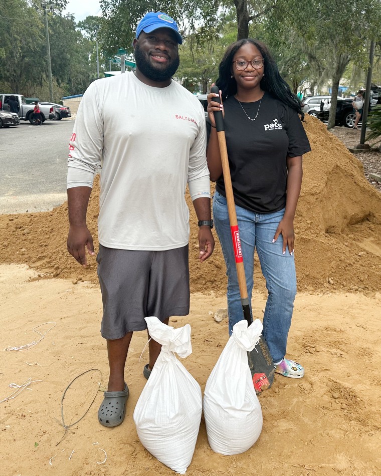 Major Thornton III and Ahmiyah Phillips, 14, prepare sandbags