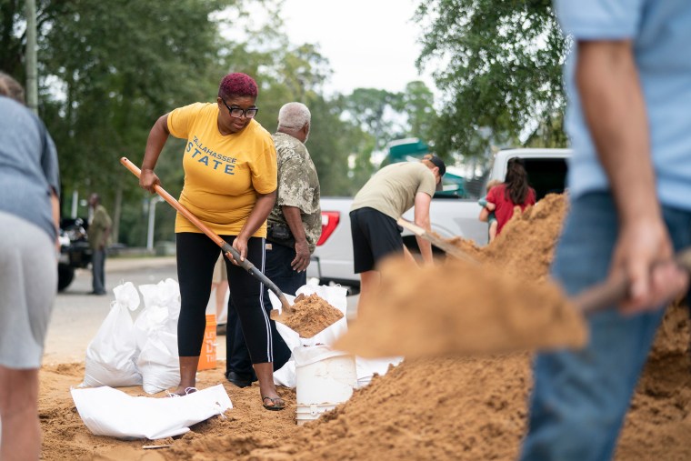 Pamela Andrews grabs sand 