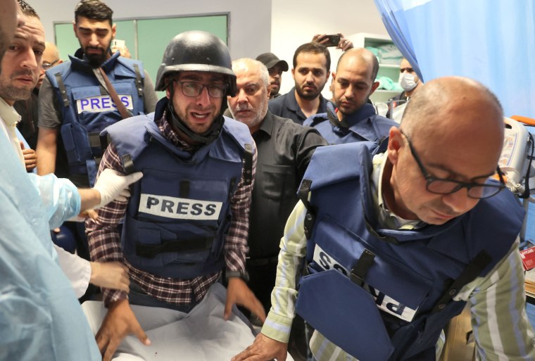 Palestinian cameraman Mujahed al-Saadi of Palestine Today TV weeps as he escorts the body of veteran Al-Jazeera reporter Shireen Abu Akleh