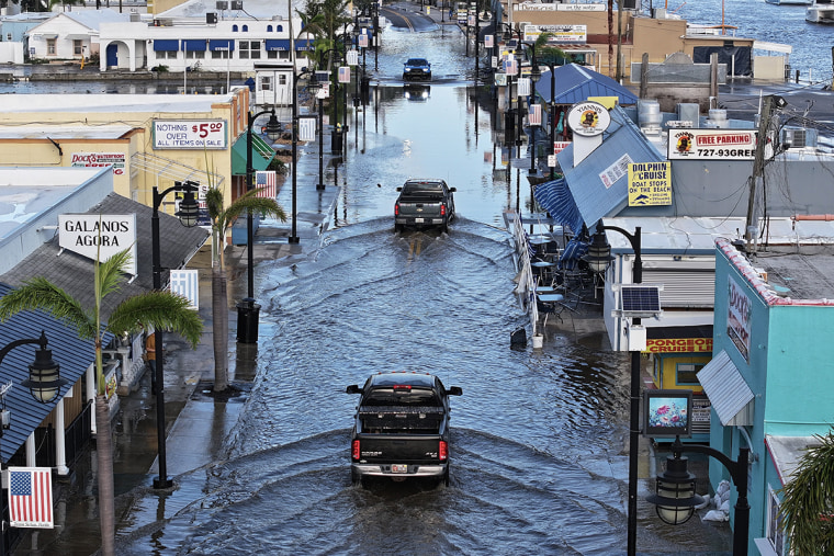 Floodwaters inundate the main street in Tarpon Springs, Fla.