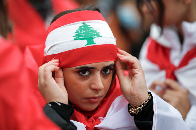 A person wears a Lebanon flag headscarf