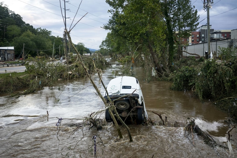 A van is partially submerged in the Swannanoa River in the aftermath of Hurricane Helene on Sept. 29, 2024 in Asheville, N.C.