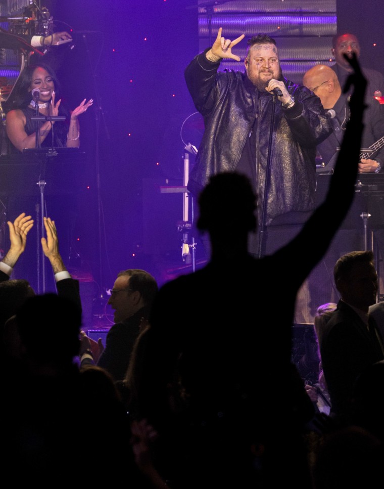 Machine Gun Kelly stands in the foreground as Jelly Roll performs during the 66th Grammy Awards Pre-Grammy Gala at the Beverly Hilton on February 3, 2024 in Beverly Hills, California.