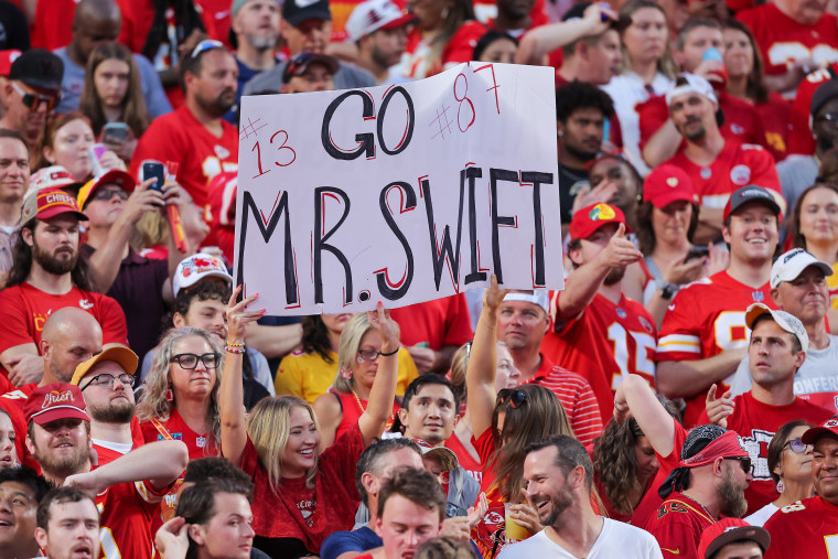 Fans hold a sign that reads, "Go Mr. Swift #13 #87" at the Kansas City Chiefs versus Baltimore Ravens game.