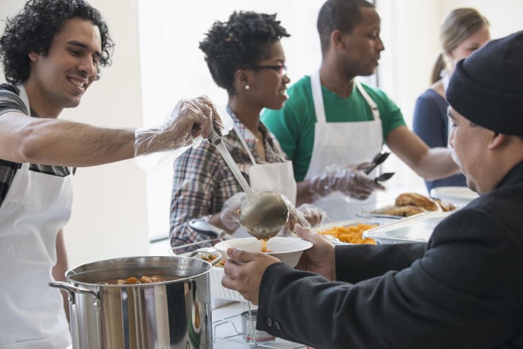 Volunteers serving food in cafeteria