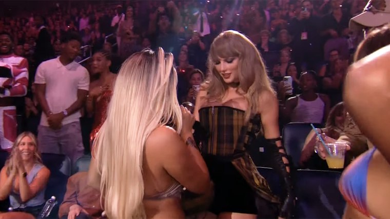 Karol G and Taylor Swift dancing.