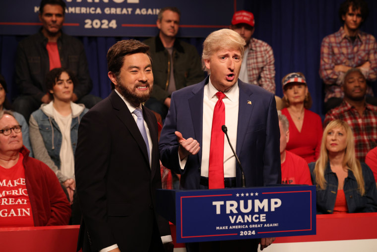 Bowen Yang as JD Vance and James Austin Johnson as Donald Trump are on stage.