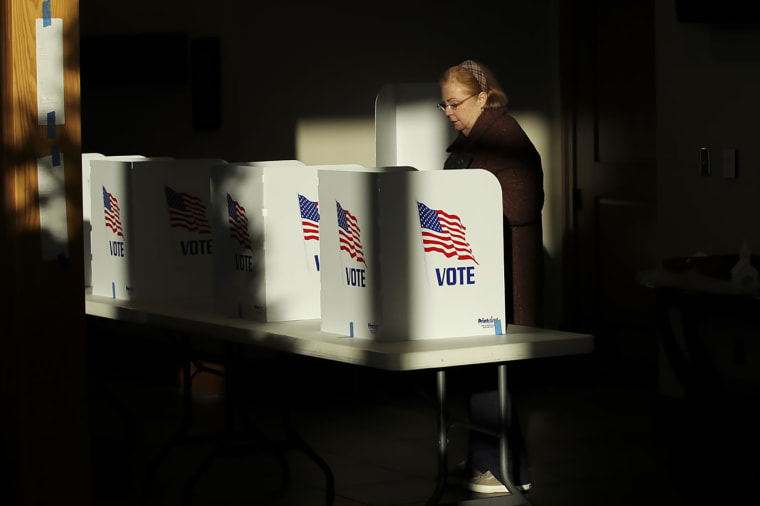 A voter casts her ballot at a polling place, in Ridgeland, Miss., on Nov. 27, 2018.