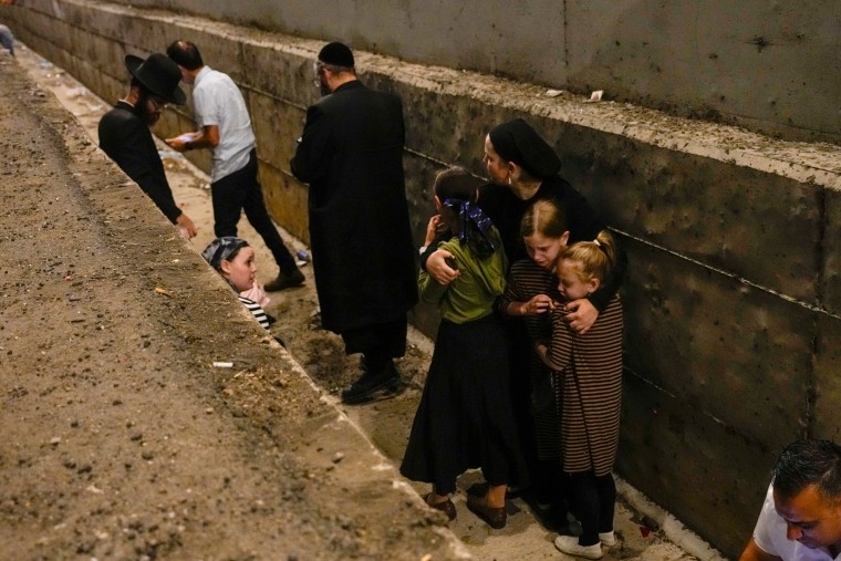 People take cover on the side of the road 