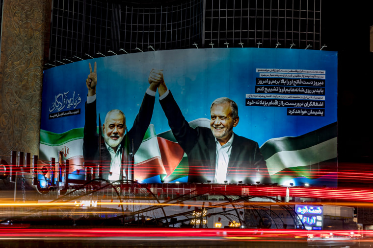 A banner with Hamas leader Ismail Haniyeh and Iranian President Masoud Pezeshkian holding hands