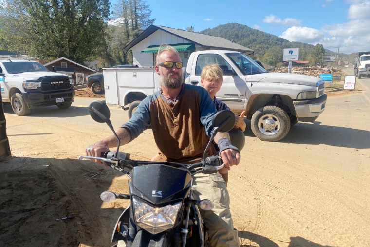 Stewart Cody with a child on his motorcycle