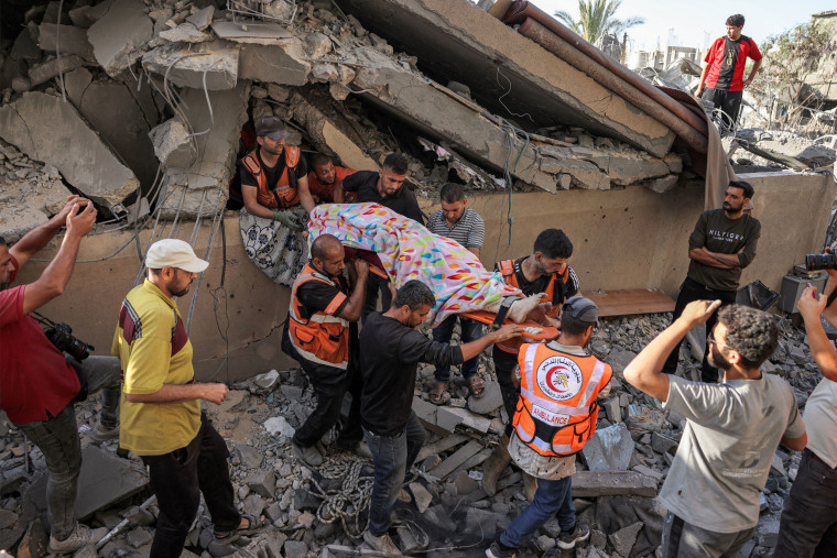 Rescuers remove a body from the rubble of a collapsed building in Khan Younis in the southern Gaza Strip on Oct. 2, 2024.