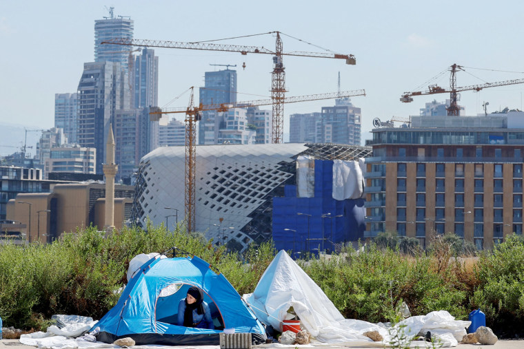 A displaced Lebanese woman peers out from a tent set up at the Beirut Marina on Oct. 3, 2024.