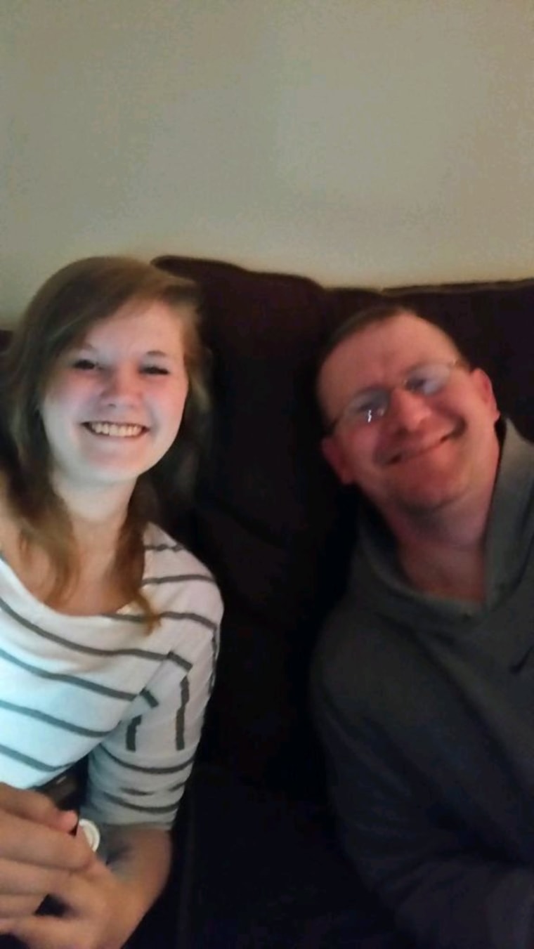 A young woman and her father on a couch 