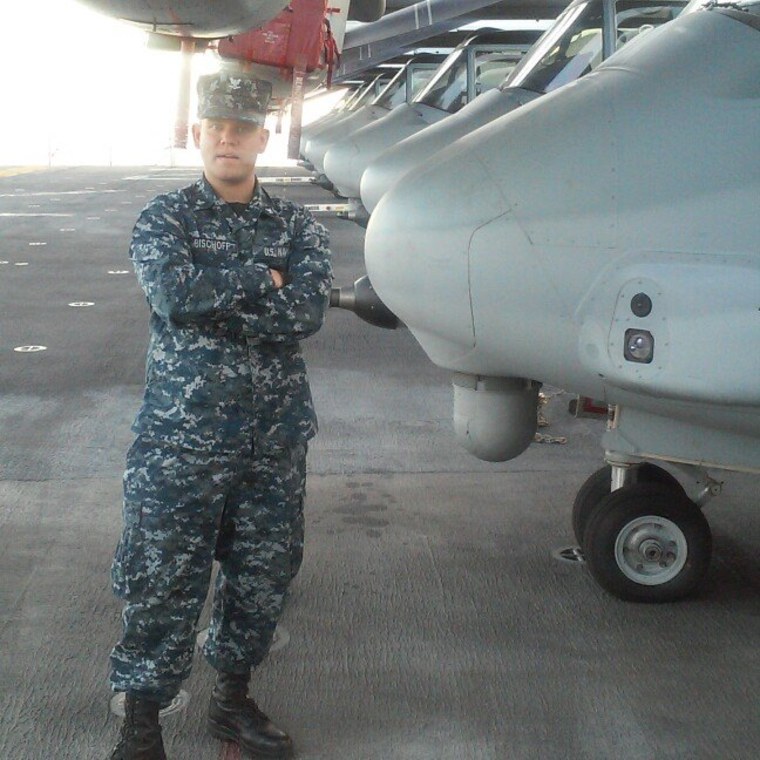 Man in naval uniform next to a plane 