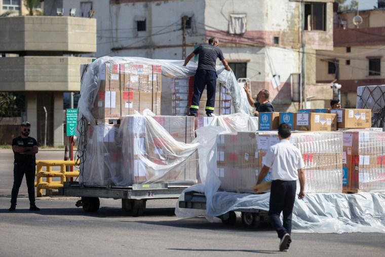 Ground staff unload a medical aid shipment at the Beirut International Airport 