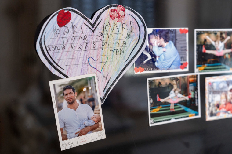 Photos on the fridge of Avital Dekel-Chen, the wife of the American Israeli hostage Sagui Dekel-Chen.