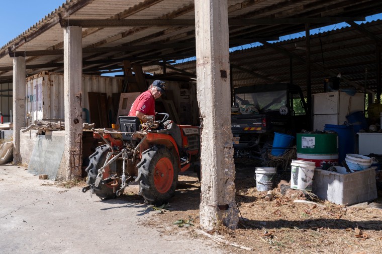 Yehuda Beinin drives Aviv Atzili’s tractor in ibbutz Shomrat, Israel.
