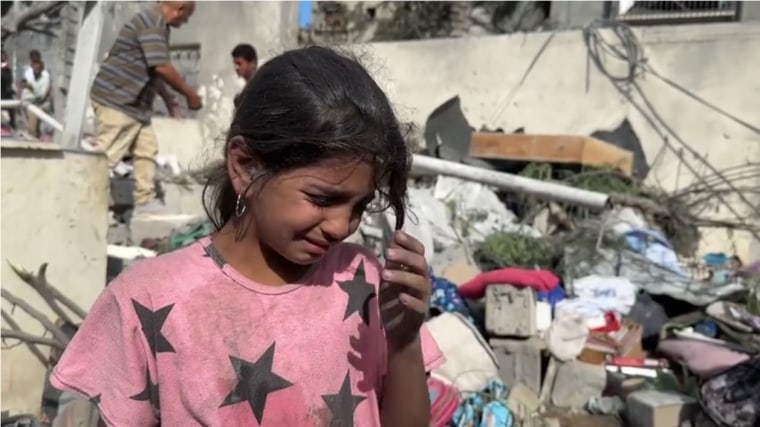 Joud Mohammed Al-Farra, 11, still covered in ash from the strike that killed her father.